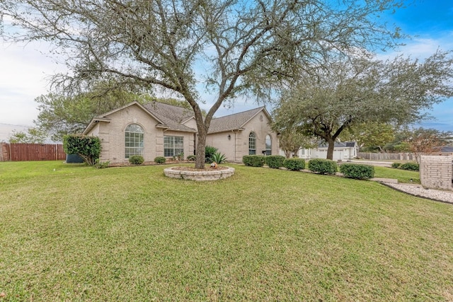 single story home featuring a front lawn