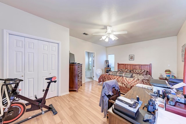 bedroom featuring ceiling fan, a closet, ensuite bathroom, and light hardwood / wood-style flooring