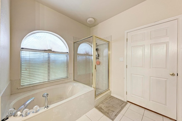 bathroom featuring tile patterned floors and shower with separate bathtub