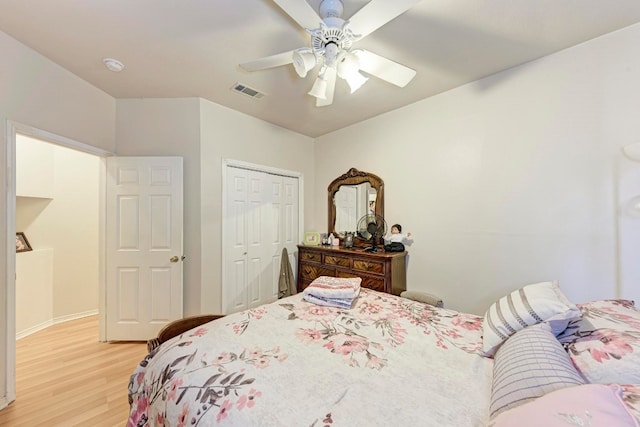 bedroom featuring a closet, ceiling fan, and light hardwood / wood-style flooring