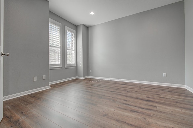 empty room with hardwood / wood-style floors