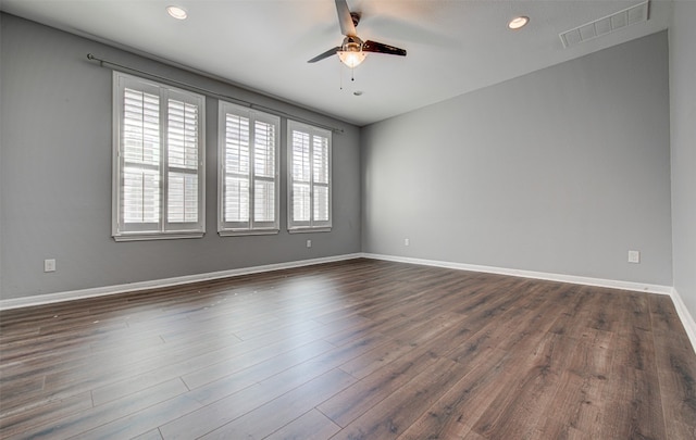 empty room featuring ceiling fan and dark hardwood / wood-style flooring