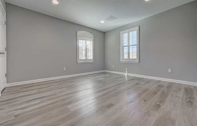 unfurnished room featuring light hardwood / wood-style floors