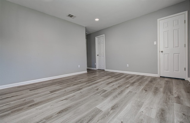 spare room with light hardwood / wood-style floors