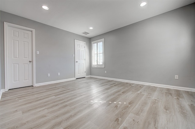 unfurnished room with light hardwood / wood-style floors