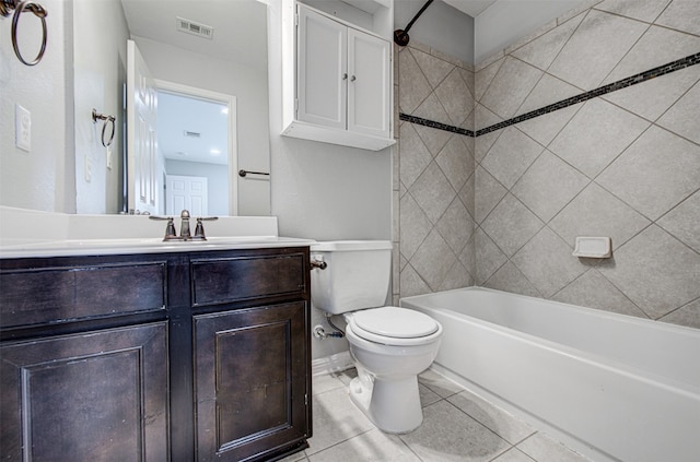 full bathroom featuring tile patterned flooring, vanity, toilet, and tiled shower / bath combo