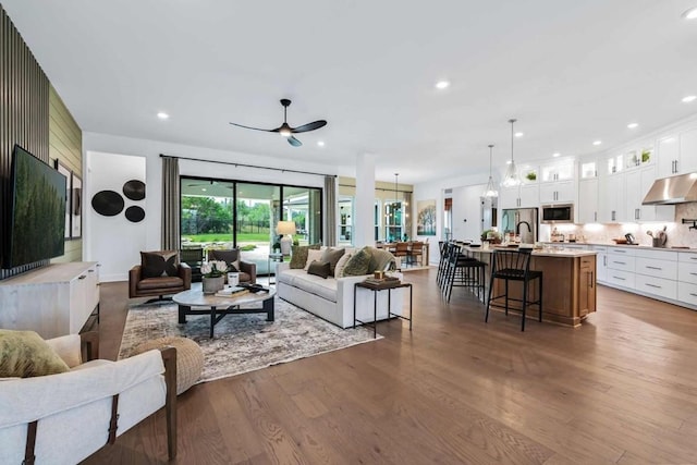 living room with ceiling fan, dark hardwood / wood-style floors, and billiards