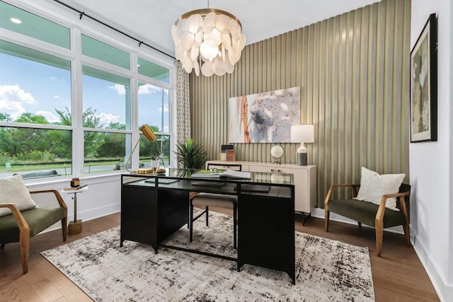 office space with a chandelier and hardwood / wood-style flooring