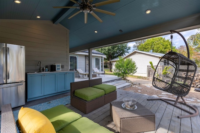 wooden terrace featuring ceiling fan, sink, and an outdoor hangout area