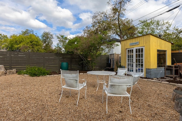 view of yard with an outbuilding and french doors