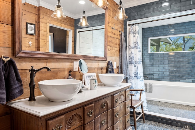 bathroom featuring ornamental molding, wood walls, and vanity