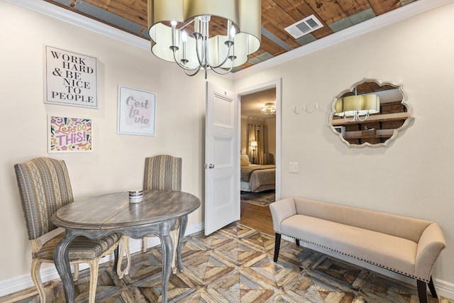 dining space with ornamental molding and a chandelier