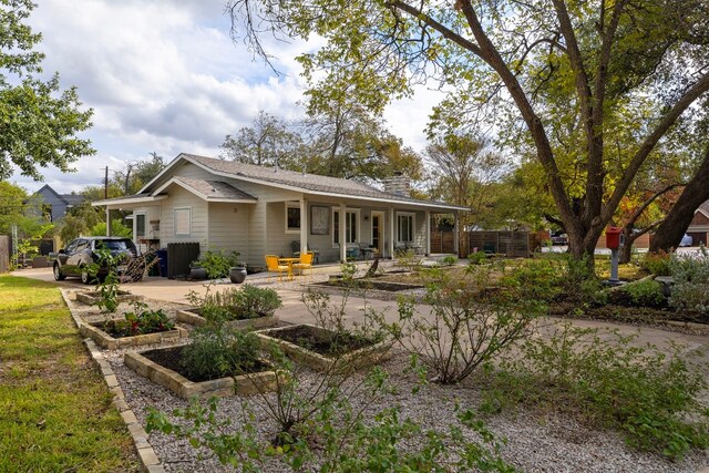 rear view of property with covered porch