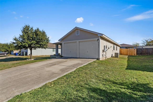 view of front facade with a front yard, a garage, and central AC unit