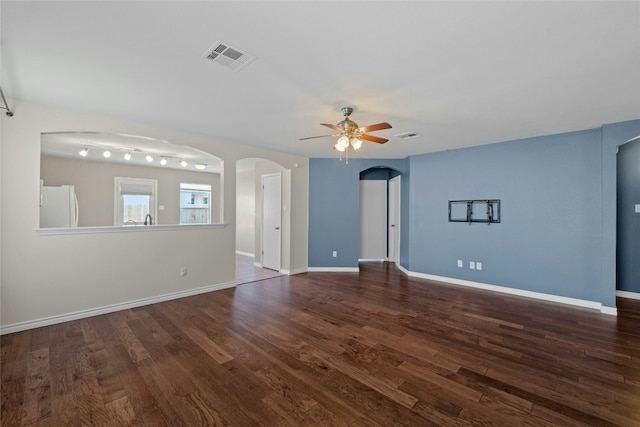 spare room with ceiling fan and dark hardwood / wood-style flooring