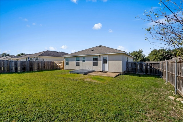 rear view of house with a patio area and a yard