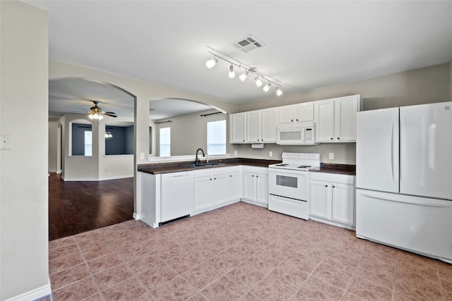 kitchen featuring white appliances, white cabinets, sink, ceiling fan, and light hardwood / wood-style floors