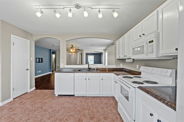 kitchen featuring sink, white cabinets, and white appliances