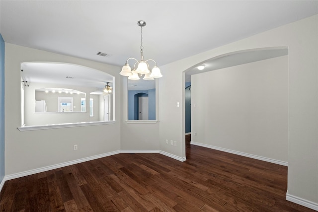 unfurnished dining area with ceiling fan with notable chandelier and dark wood-type flooring