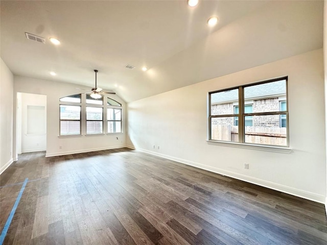 empty room with dark hardwood / wood-style floors, ceiling fan, and vaulted ceiling