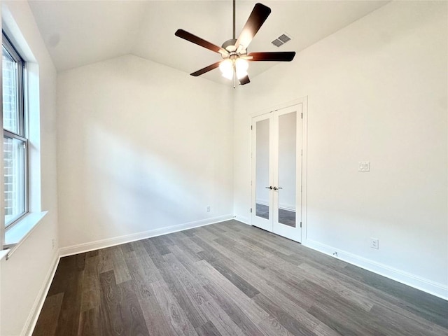 unfurnished room featuring french doors, lofted ceiling, ceiling fan, and dark wood-type flooring