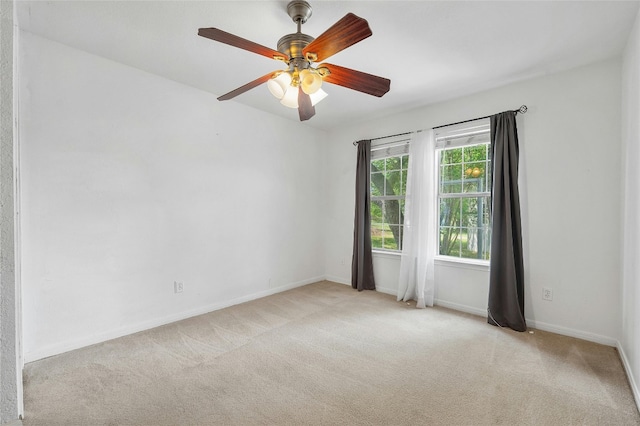 carpeted spare room featuring ceiling fan