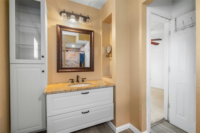 bathroom with ceiling fan, vanity, and hardwood / wood-style flooring