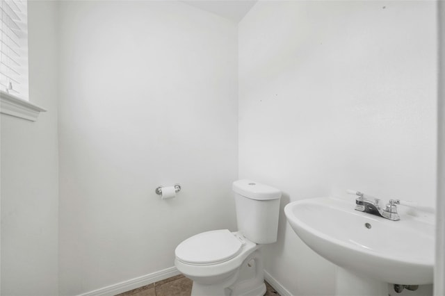 bathroom with tile patterned floors, sink, and toilet