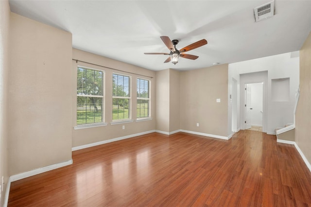 unfurnished room featuring ceiling fan and hardwood / wood-style floors