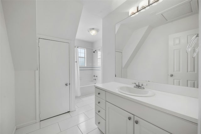 bathroom with tile patterned floors, tiled shower / bath combo, and vanity