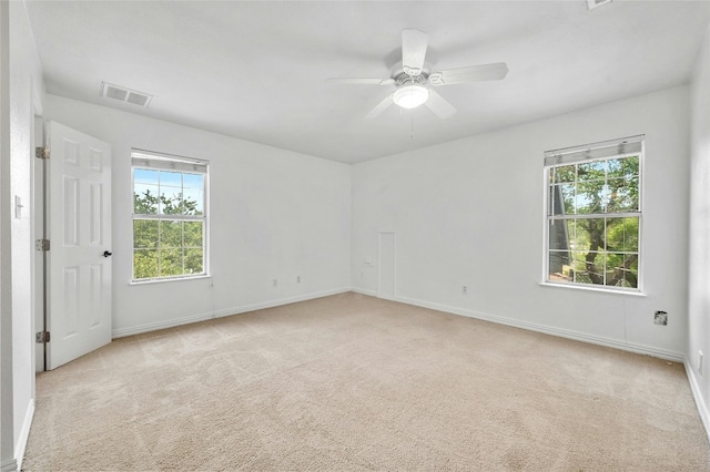 carpeted spare room with ceiling fan