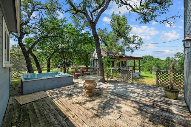 wooden terrace featuring a hot tub