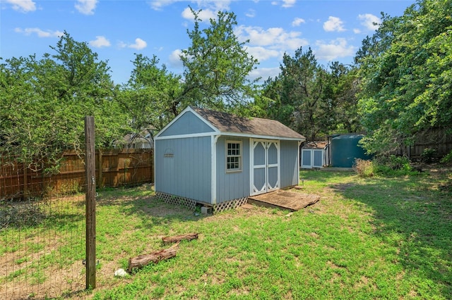 view of outbuilding featuring a yard