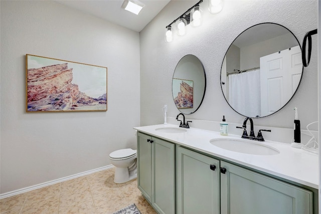 bathroom featuring tile patterned floors, vanity, and toilet