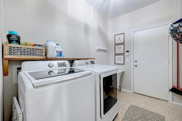 laundry room featuring light tile patterned floors and separate washer and dryer