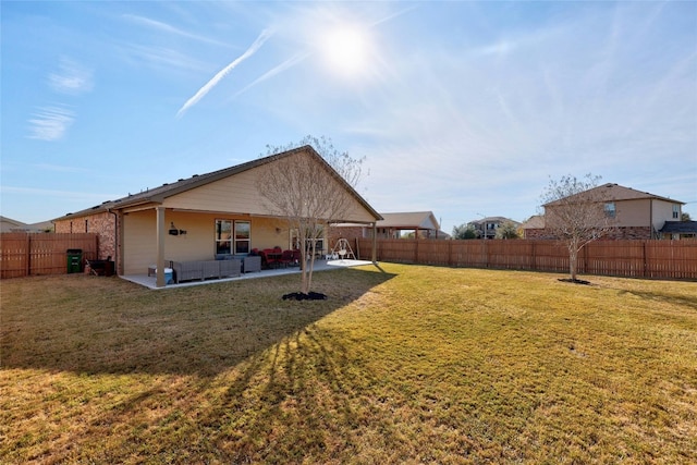 rear view of house featuring a patio area, a yard, and an outdoor hangout area