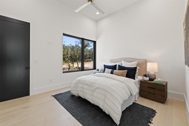 bedroom with light hardwood / wood-style floors and ceiling fan