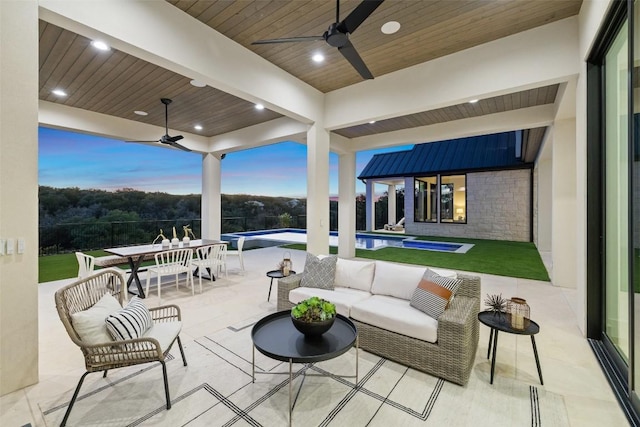 patio terrace at dusk featuring outdoor lounge area