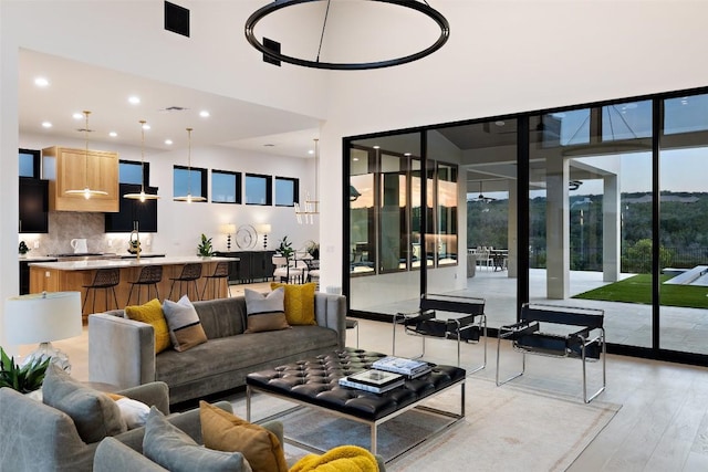 living room featuring sink and light hardwood / wood-style floors