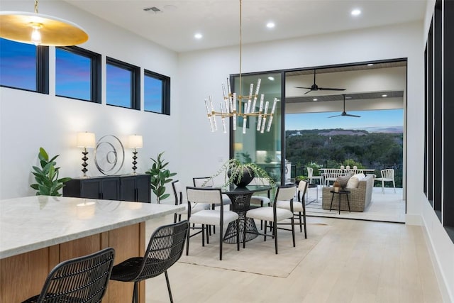 dining space featuring ceiling fan and light wood-type flooring