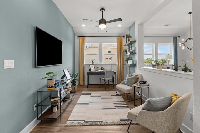 living area with ceiling fan and wood-type flooring