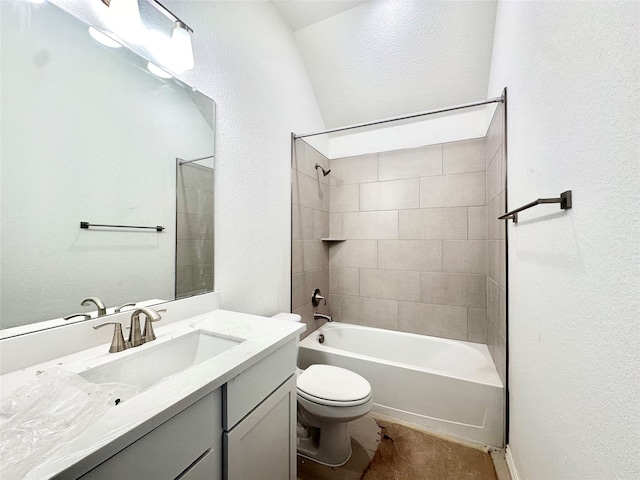 full bathroom featuring toilet, tiled shower / bath combo, and vanity