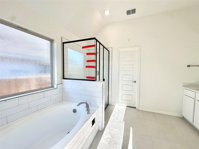 bathroom with vaulted ceiling, tile patterned flooring, plus walk in shower, and vanity