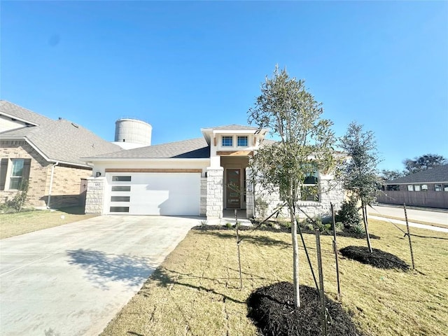 view of front facade with a garage and a front yard