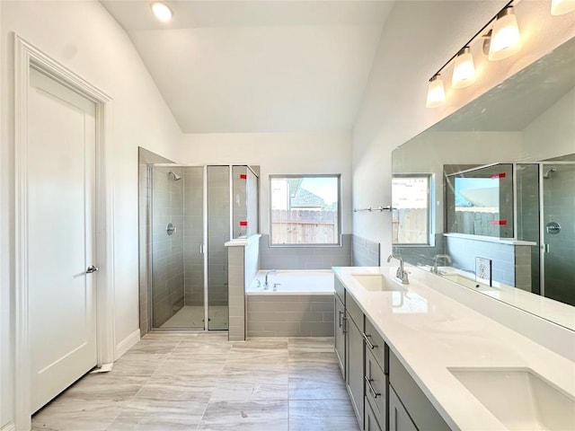 bathroom with lofted ceiling, independent shower and bath, and vanity