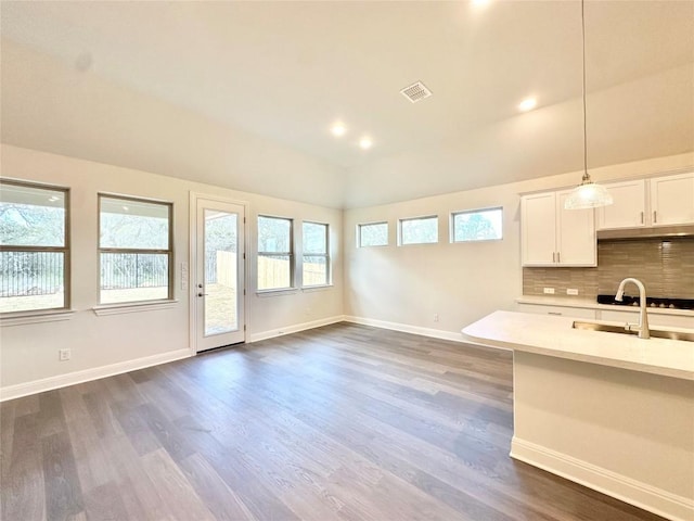 kitchen featuring decorative light fixtures, white cabinetry, dark hardwood / wood-style flooring, tasteful backsplash, and sink