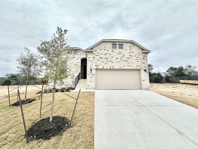 view of front of house featuring a garage and a front yard