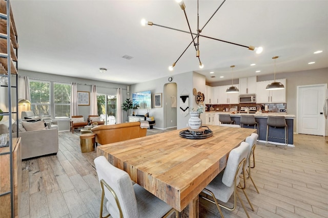 dining room featuring light hardwood / wood-style floors and an inviting chandelier