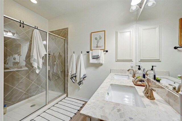 bathroom with vanity, hardwood / wood-style flooring, and an enclosed shower