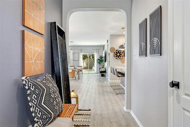 corridor with light hardwood / wood-style floors